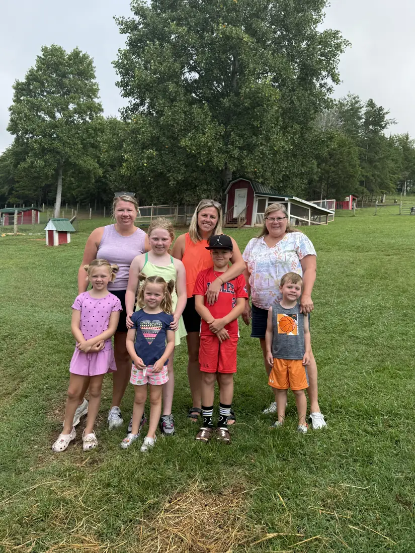 A family group posing together in the pasture