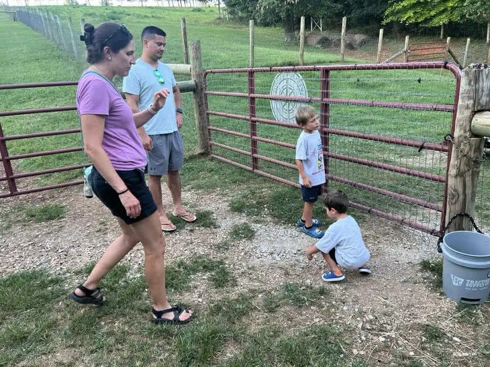 A family walking through the pasture gate